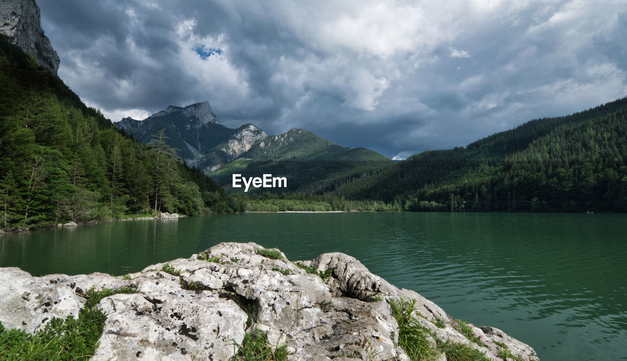 Scenic view of lake and mountains against sky