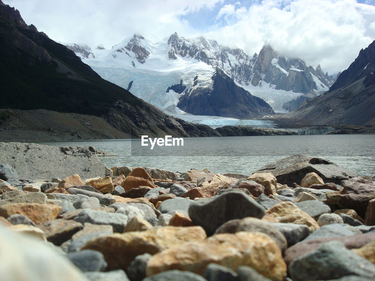 Scenic view of mountains and river against sky