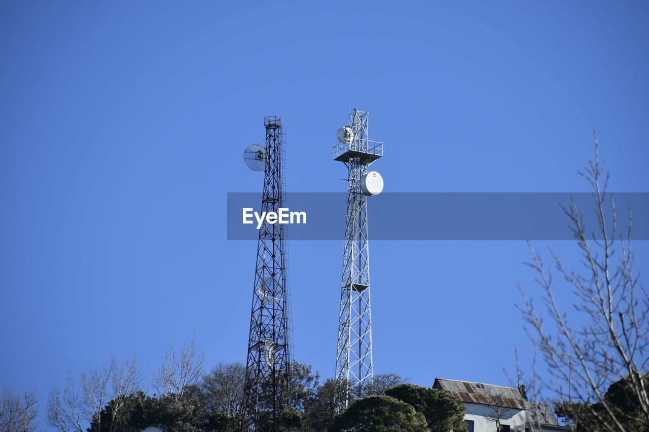 sky, clear sky, tower, technology, communications tower, blue, broadcasting, architecture, low angle view, nature, built structure, communication, tree, no people, global communications, plant, antenna, telecommunications equipment, satellite dish, satellite, day, wireless technology, sunny, outdoors, street light, electricity, lighting, overhead power line, copy space, metal, telecommunications engineering, spire