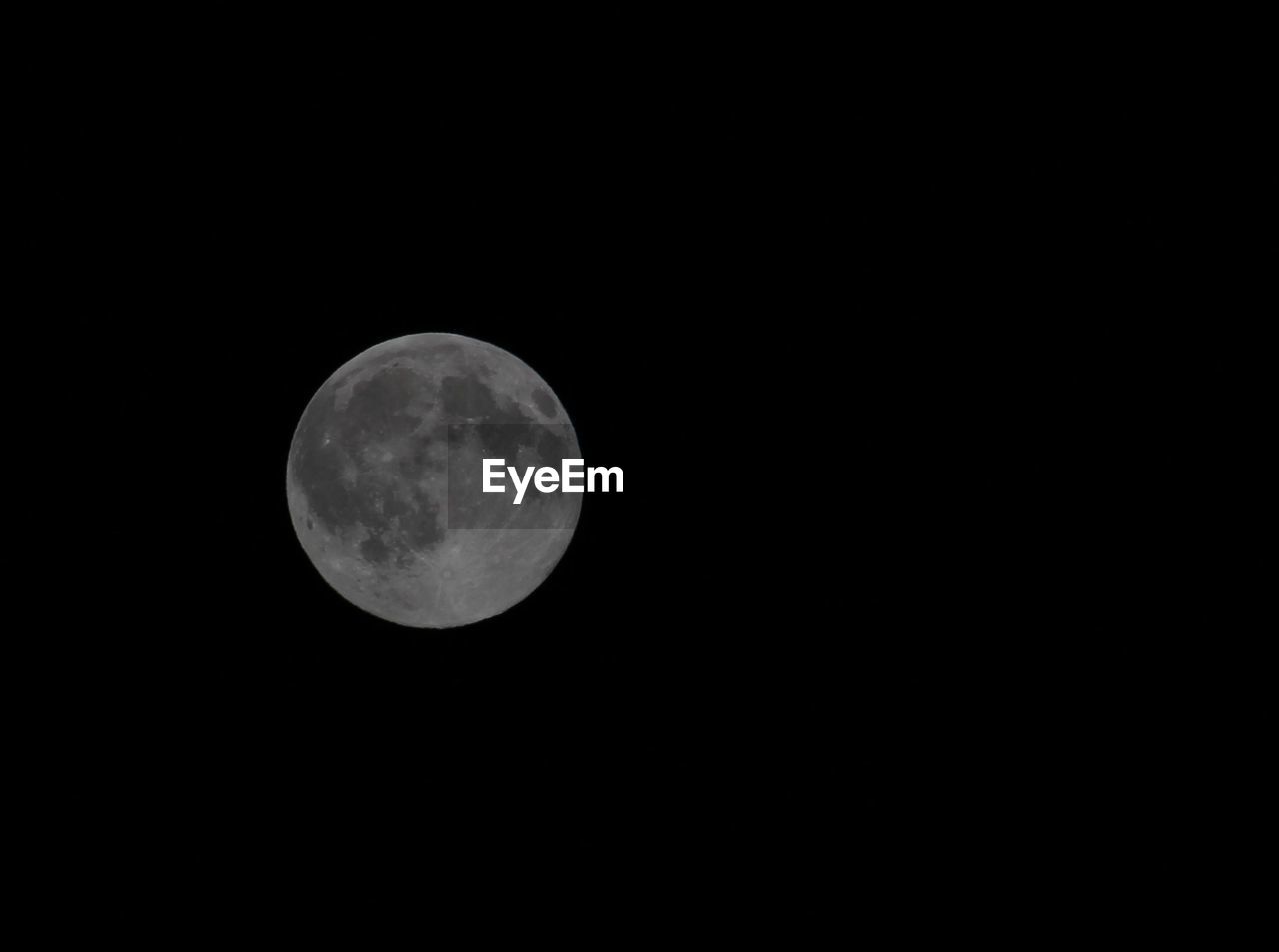 Low angle view of moon against clear sky at night