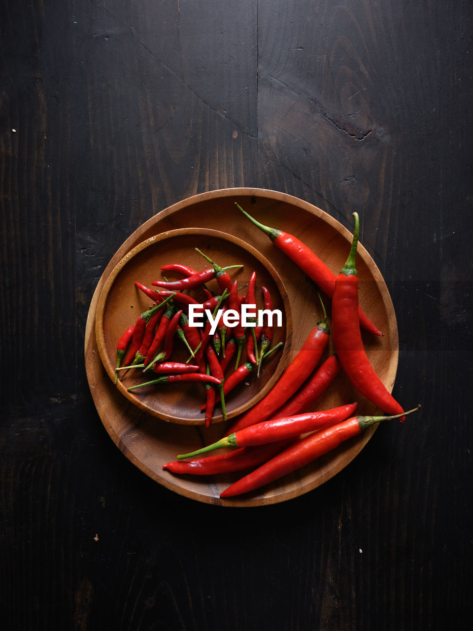 CLOSE-UP OF RED CHILI PEPPERS ON TABLE