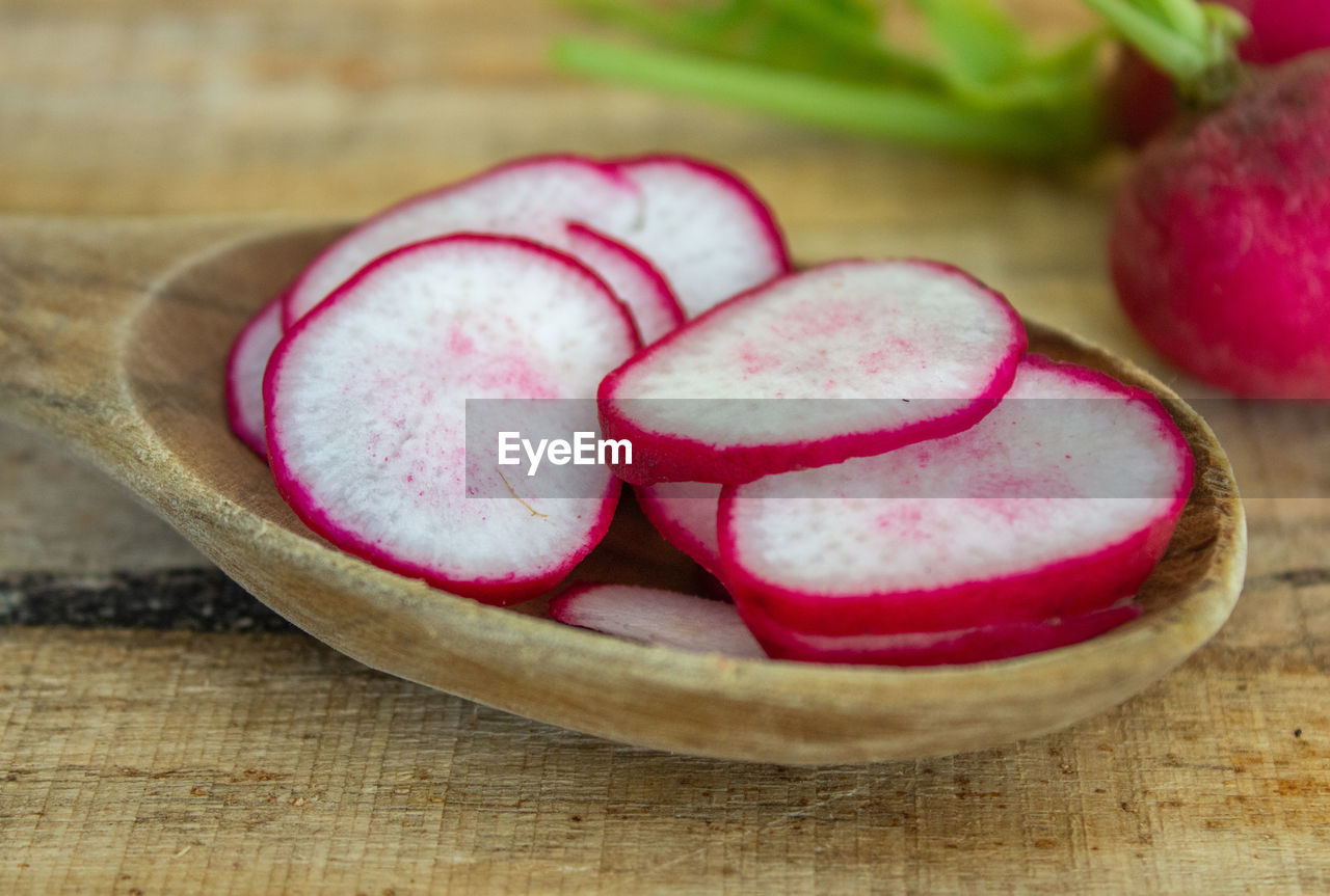 food and drink, food, healthy eating, freshness, wellbeing, radish, produce, wood, slice, indoors, fruit, vegetable, no people, plant, cross section, still life, close-up, studio shot, cutting board, halved, red, pink, table