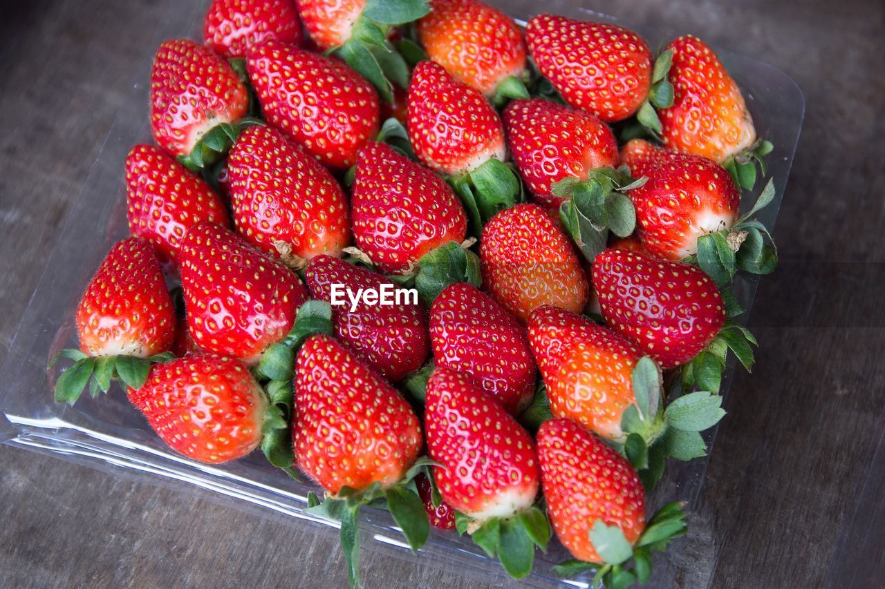 High angle view of strawberries in plastic container