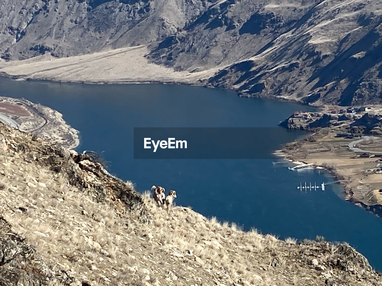 HIGH ANGLE VIEW OF LAKE AGAINST MOUNTAIN RANGE