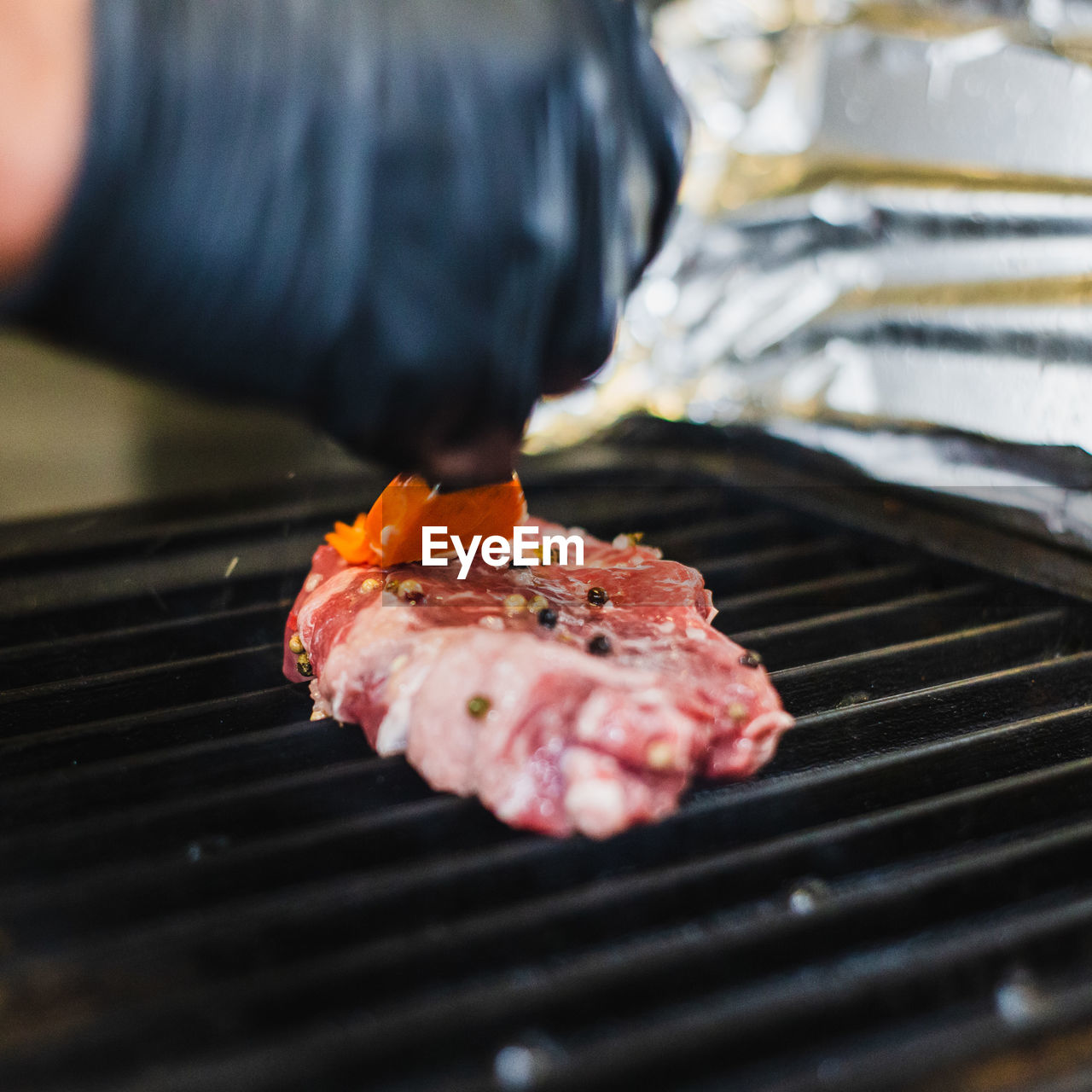 CLOSE-UP OF MEAT ON GRILL