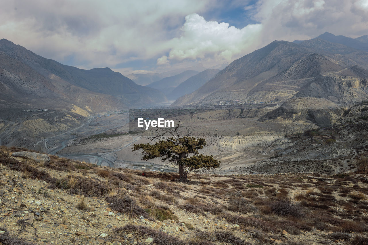 Scenic view of valley and mountains against sky