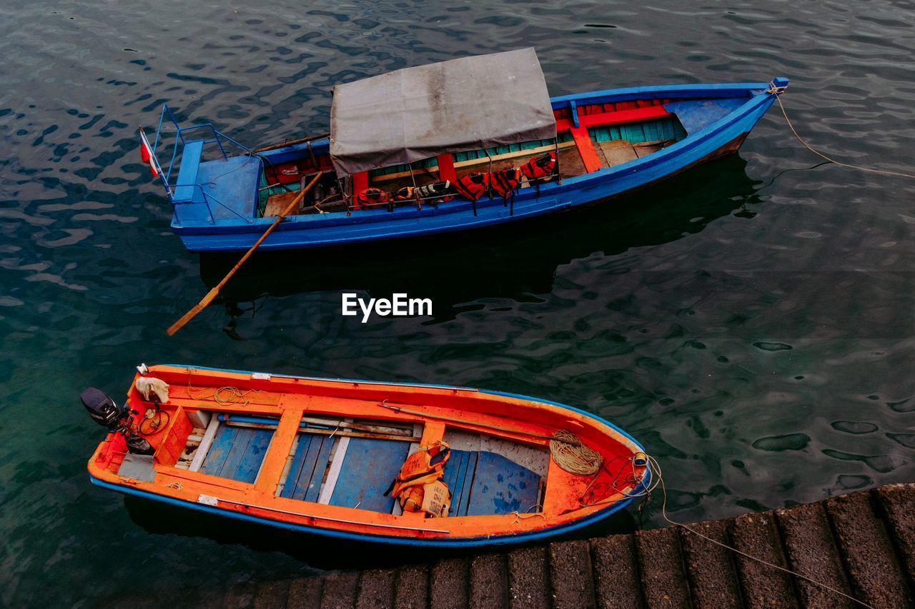 High angle view of boats moored at harbor