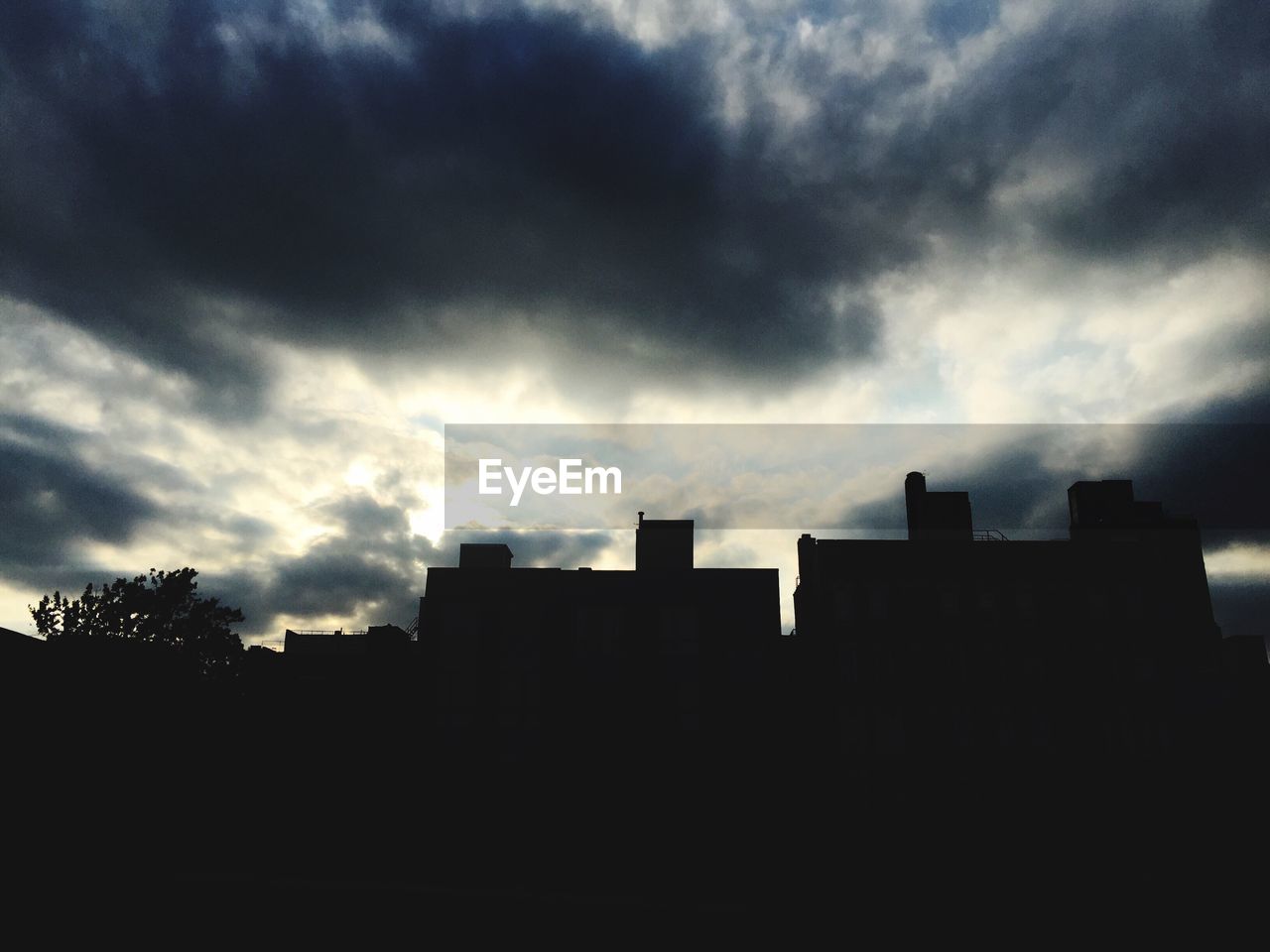 SILHOUETTE STRUCTURES AGAINST CLOUDY SKY