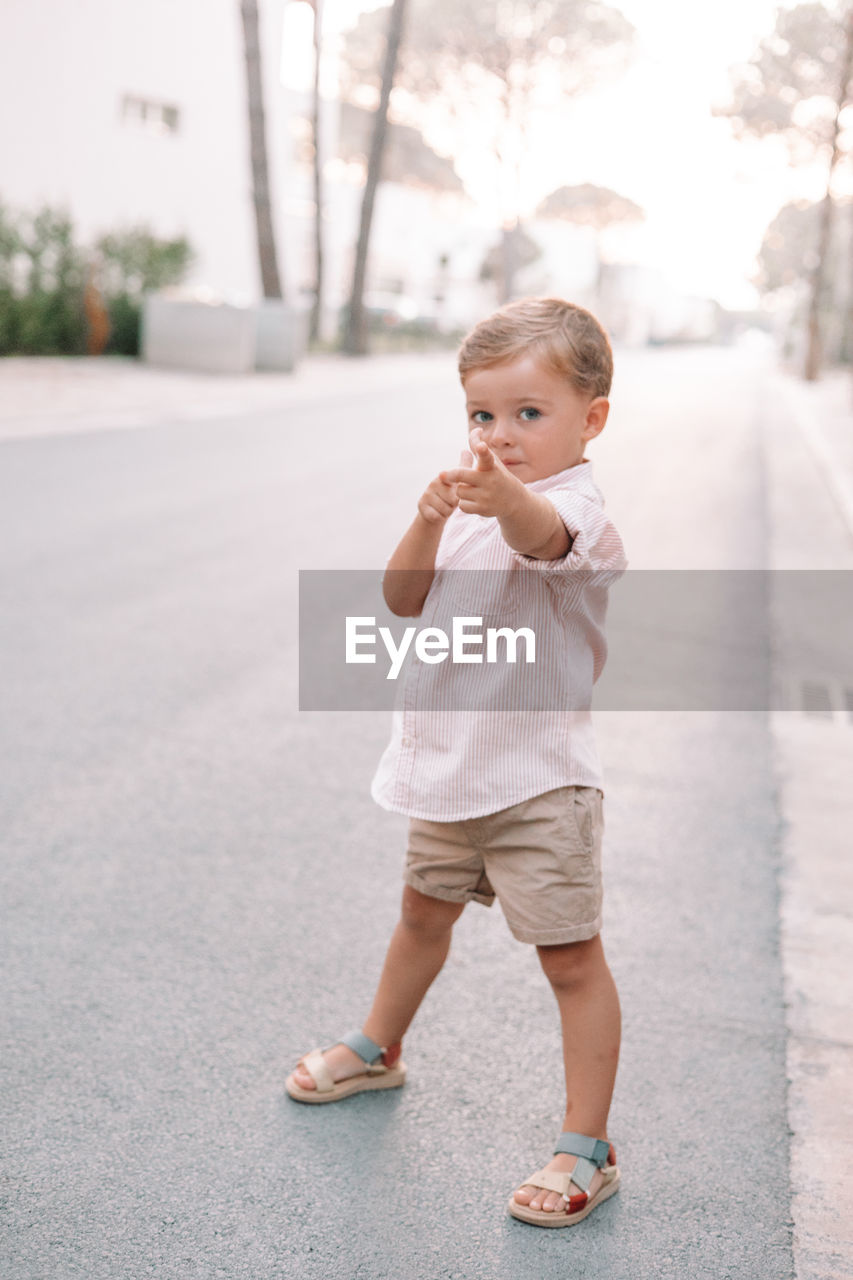 child, childhood, full length, one person, baby, spring, cute, toddler, innocence, casual clothing, day, portrait, standing, emotion, looking, person, city, baby clothing, clothing, outdoors, nature, happiness, blond hair, lifestyles, smiling, architecture, men, street, white, looking away, human face, copy space