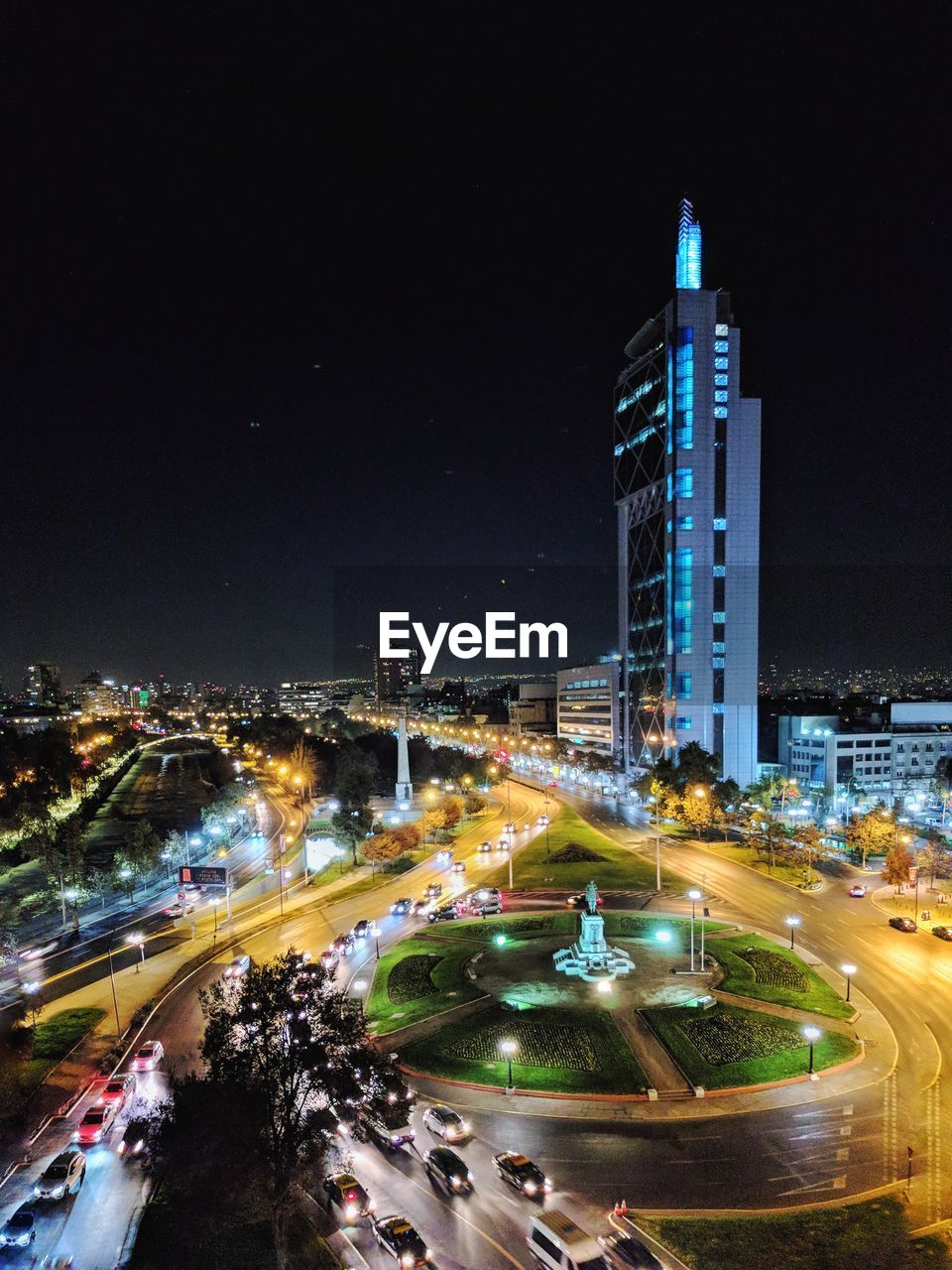 HIGH ANGLE VIEW OF ILLUMINATED STREET AND BUILDINGS AT NIGHT