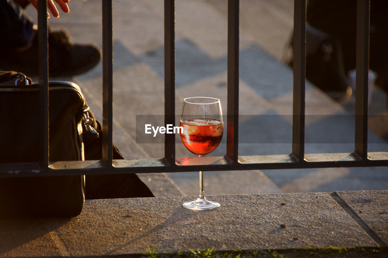 Red wine glass on table by window