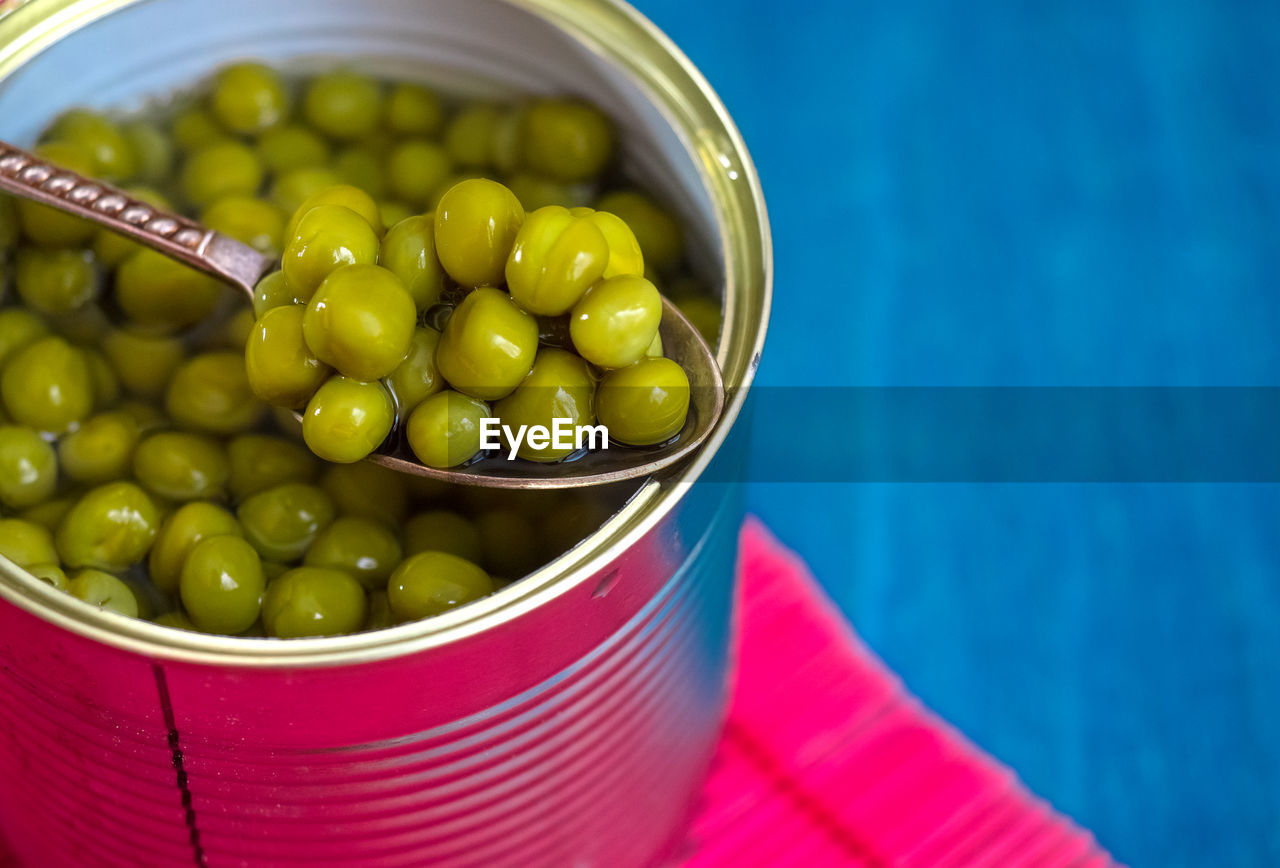 Close-up of green peas in container