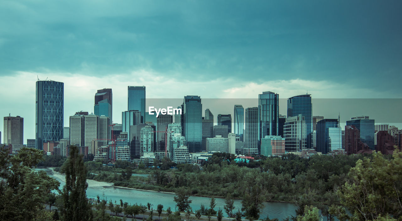 View of skyscrapers against cloudy sky