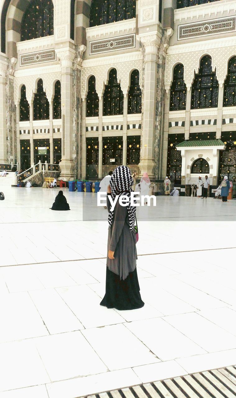 Full length of woman standing at al-haram mosque