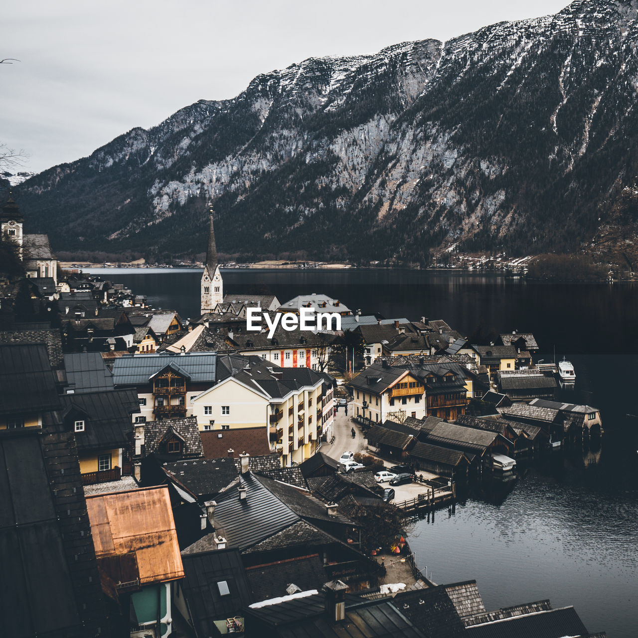 High angle view of town by mountain against sky