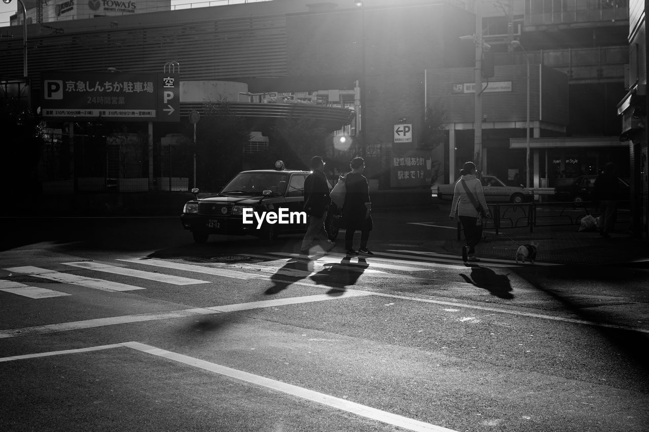 VIEW OF PEOPLE CROSSING ROAD