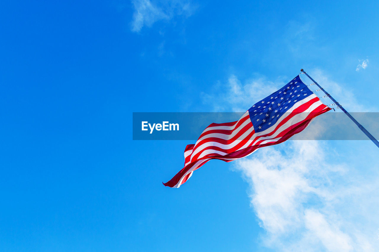 low angle view of american flag against sky