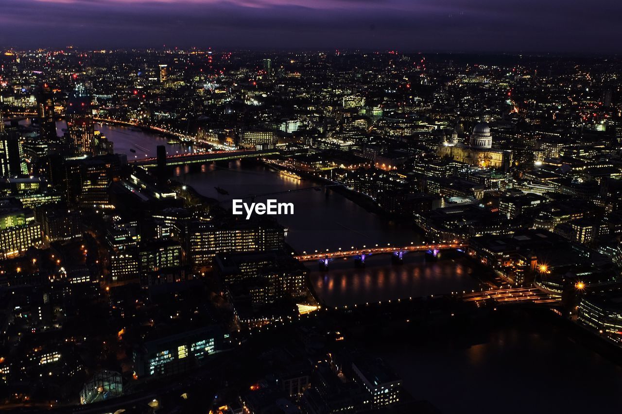 Aerial view of city lit up at night