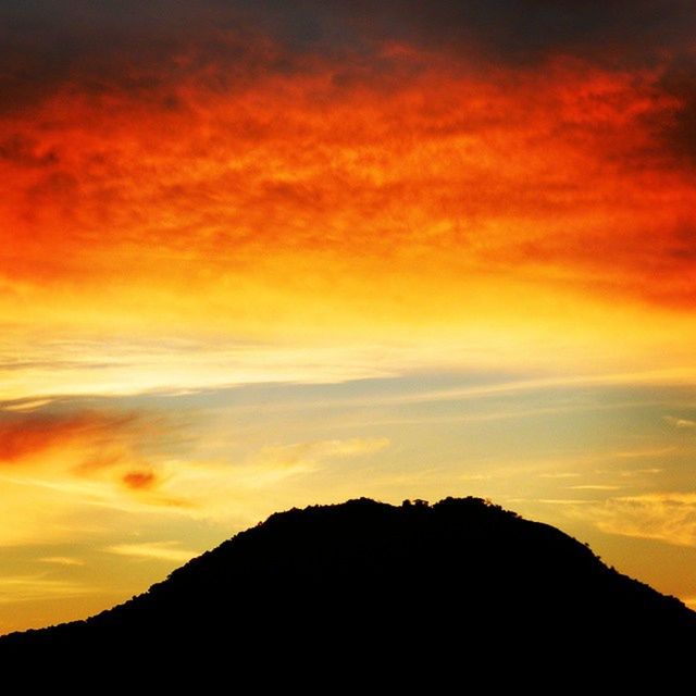 SCENIC VIEW OF MOUNTAINS AT SUNSET