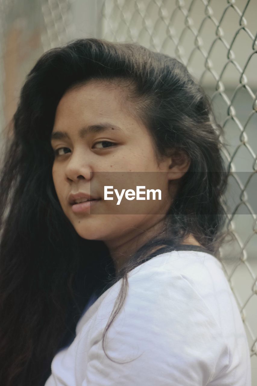 PORTRAIT OF A YOUNG WOMAN LOOKING AWAY