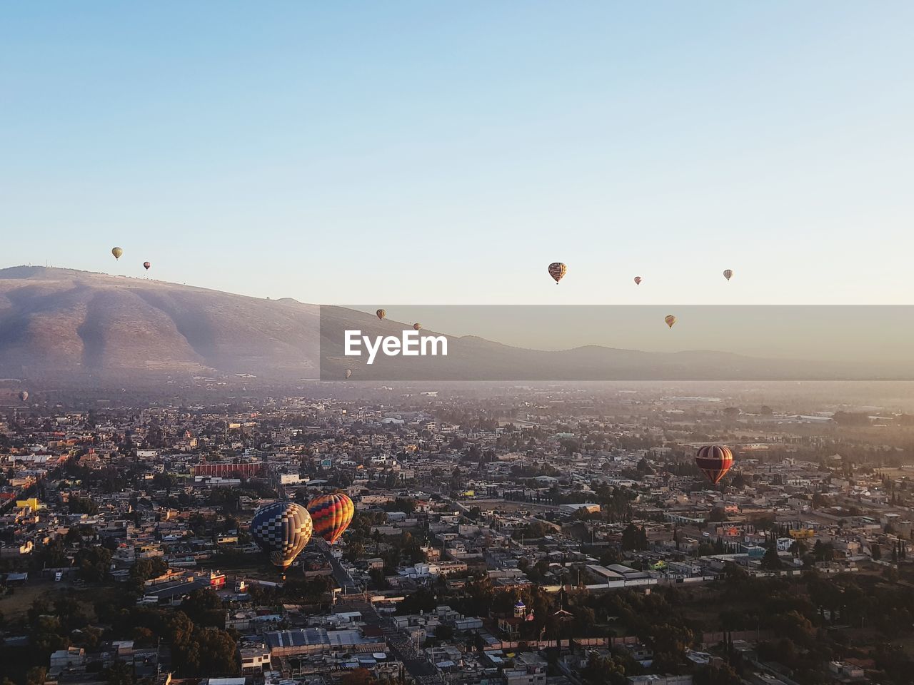 Hot air balloons flying in city