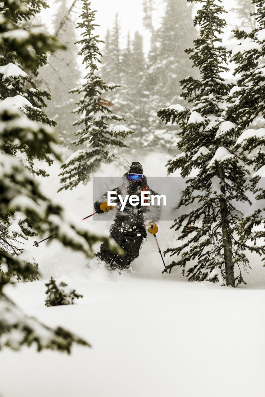 Man skiing on snow covered field