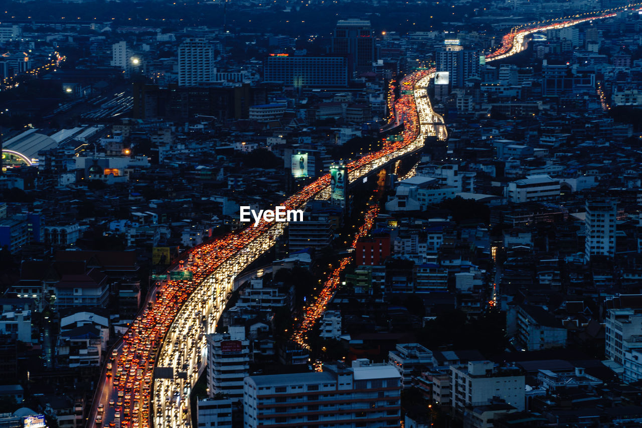 Aerial view of illuminated vehicles on street in city