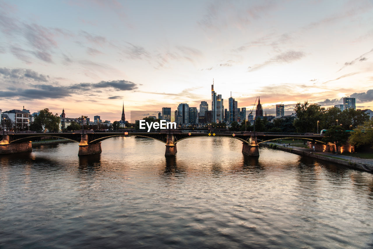 View of bridge over river against buildings in city