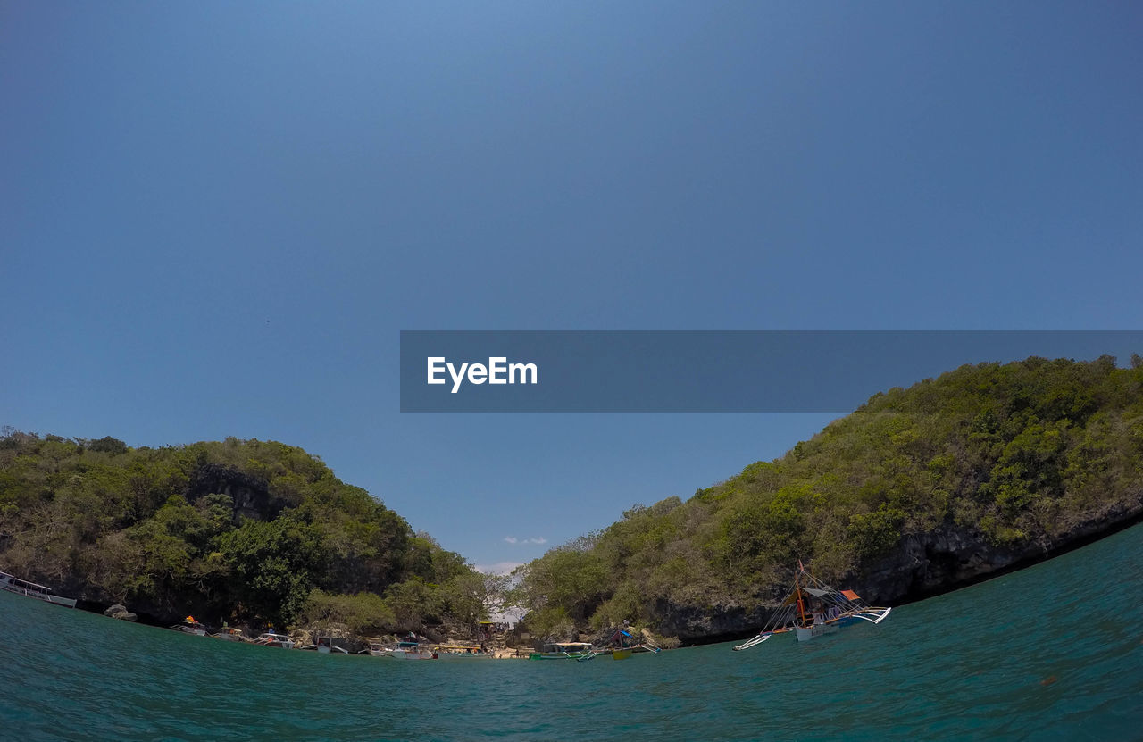 Scenic view of sea against clear blue sky