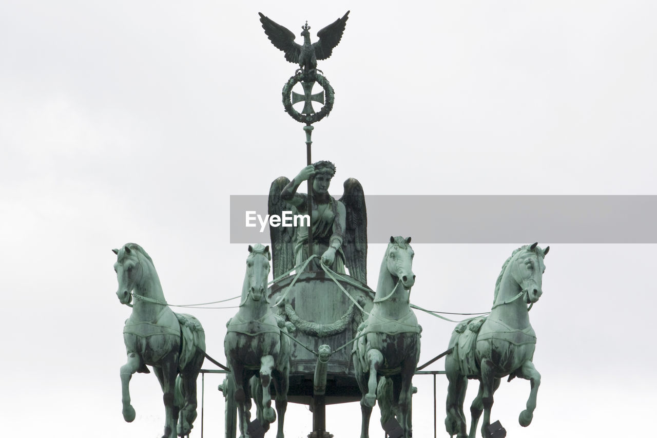 Low angle view of quadriga statue against clear sky