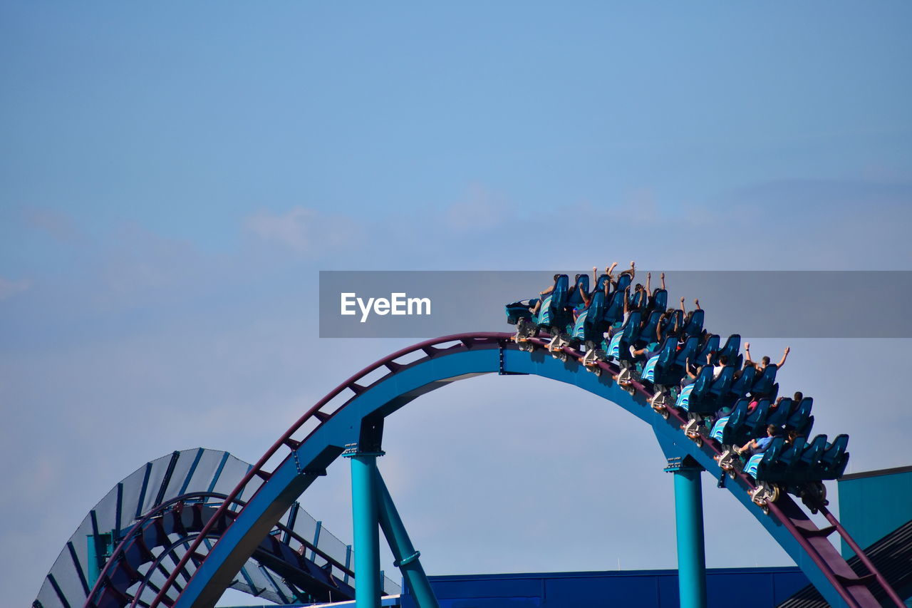 LOW ANGLE VIEW OF AMUSEMENT PARK AGAINST SKY