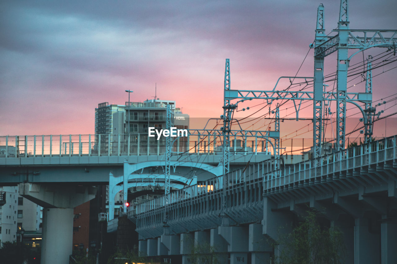 BRIDGE AGAINST SKY AT SUNSET