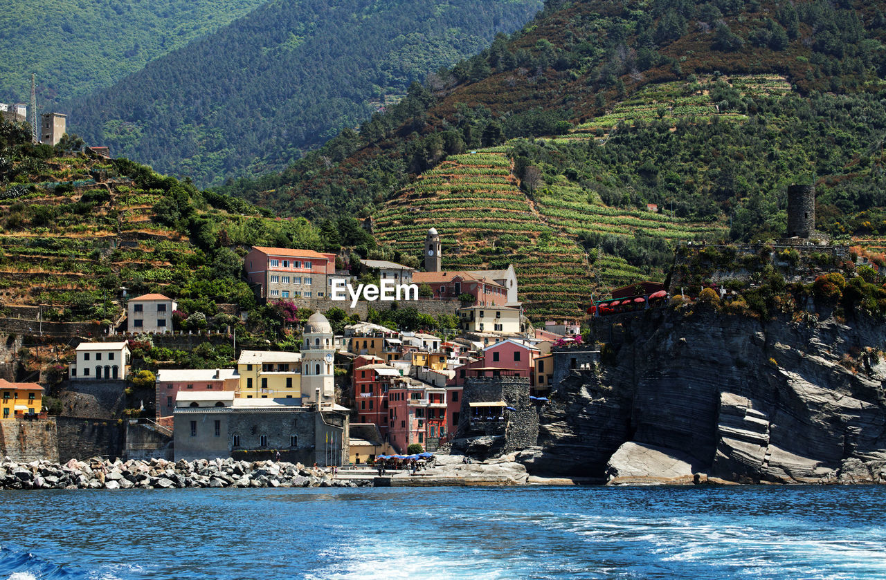 Buildings on mountain by sea at cinque terre