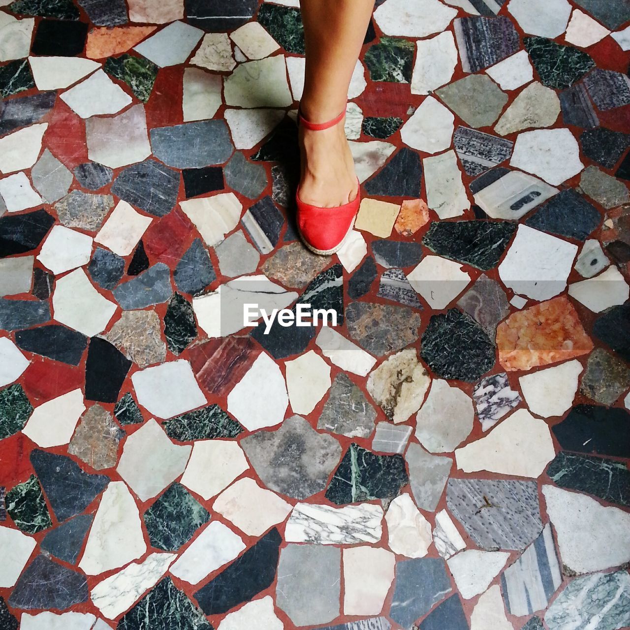 Low section of woman on cobblestone