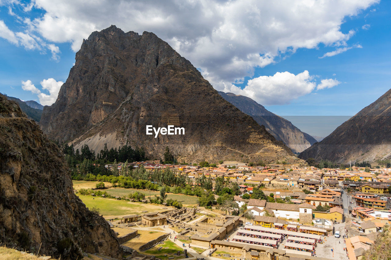 panoramic view of townscape and mountains against sky