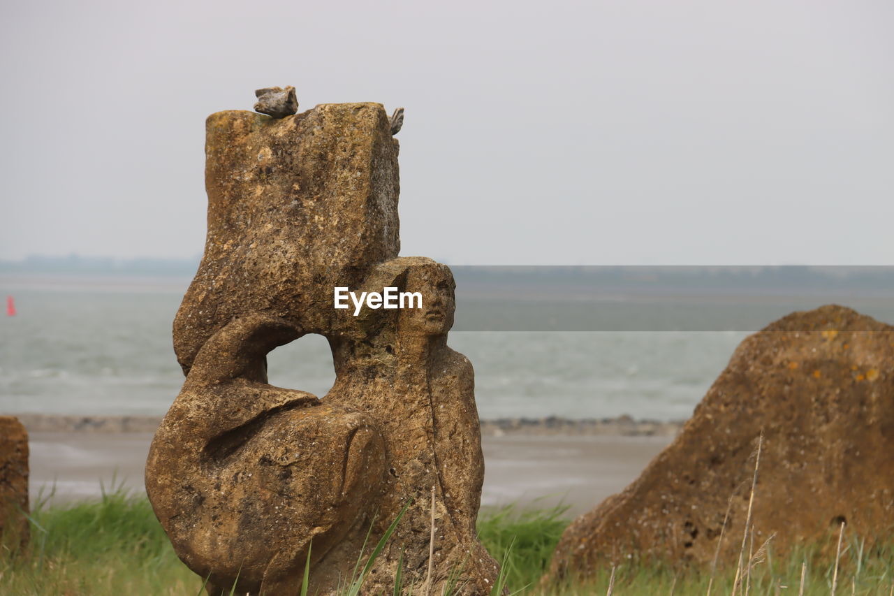 rock, sculpture, nature, land, no people, water, sky, sea, beach, ancient history, grass, day, sand, monument, plant, outdoors, history, travel destinations, tranquility, animal, terrain, the past, scenics - nature, statue, animal themes, environment, landscape, focus on foreground, craft