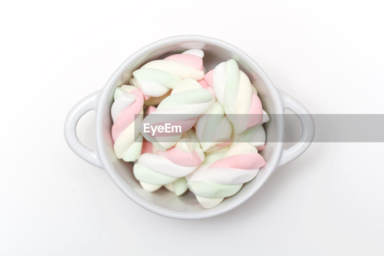 High angle view of marshmallow in bowl against white background