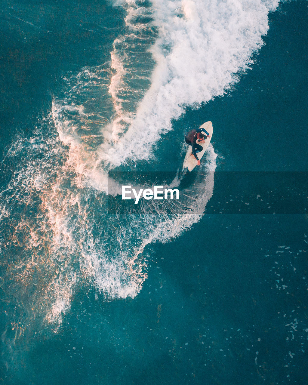 HIGH ANGLE VIEW OF PERSON SWIMMING IN POOL