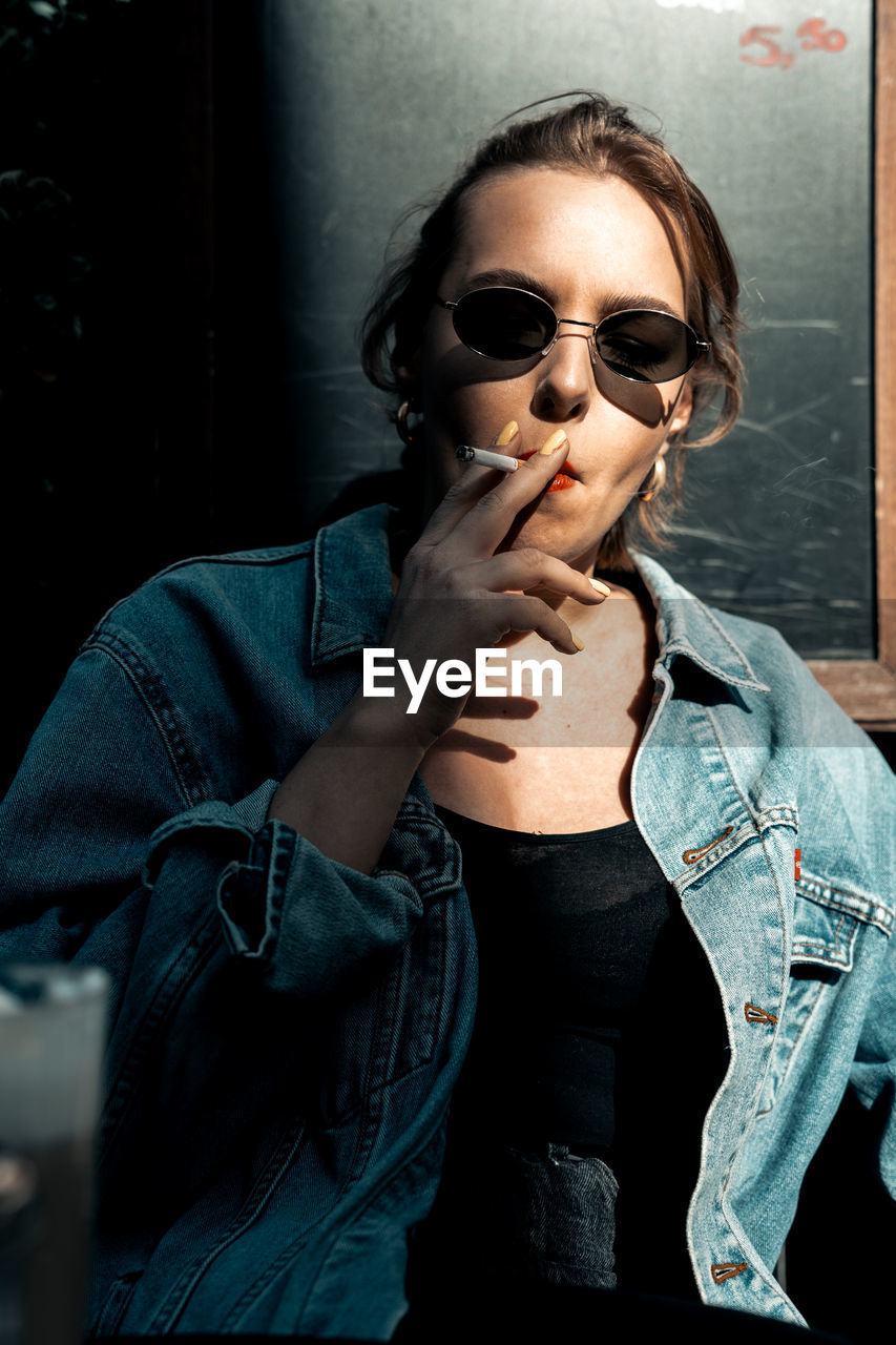 Young woman smoking cigarette