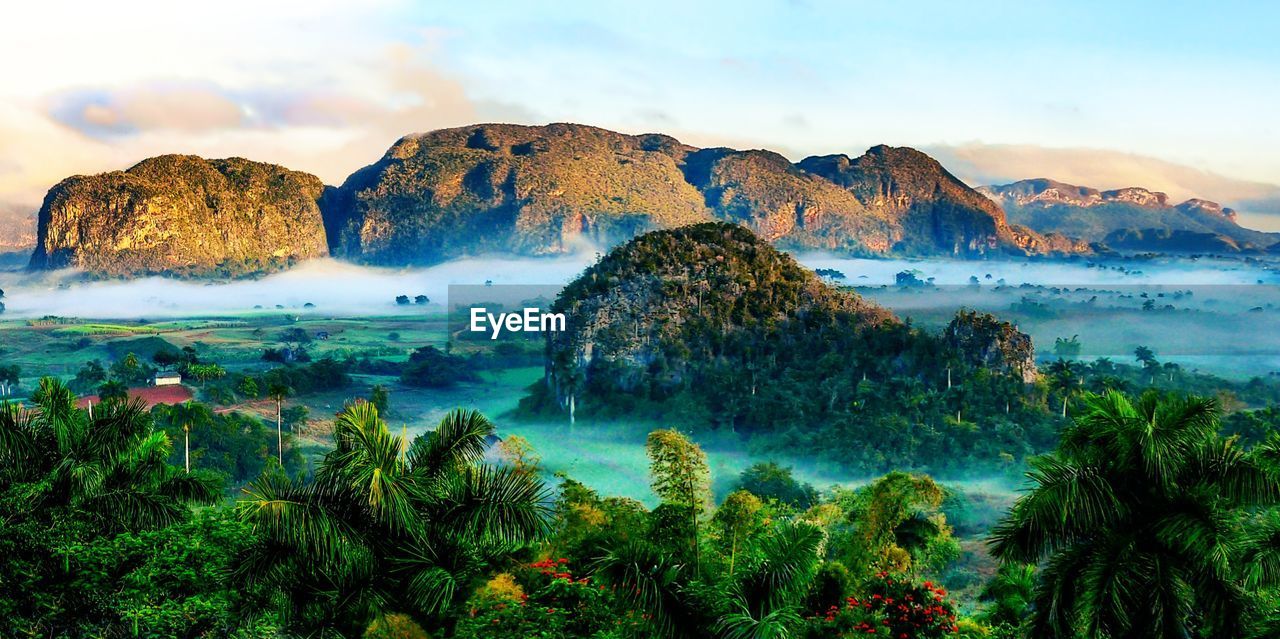 Scenic view of sea and mountains against sky