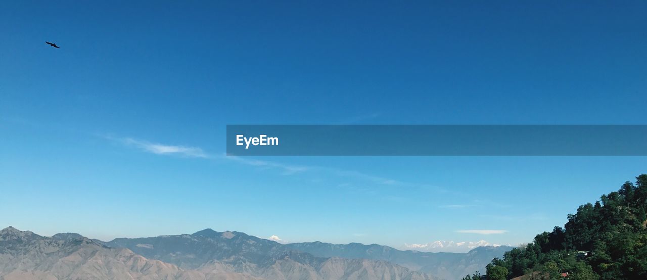 SCENIC VIEW OF BLUE SKY AND MOUNTAINS AGAINST CLEAR BACKGROUND