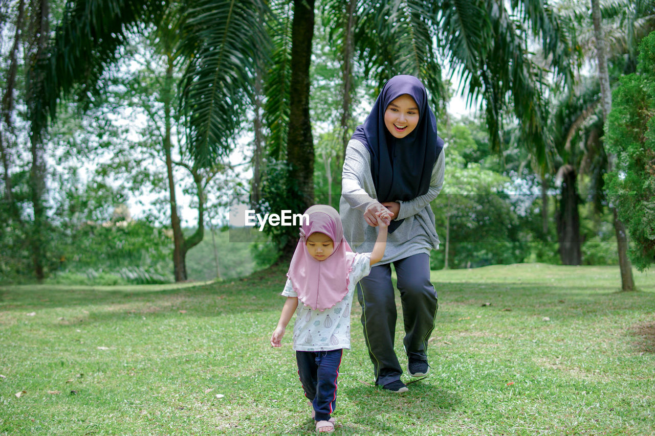 Beautiful asian mom and baby playing happiness in the park , outdoor ,mother day concept