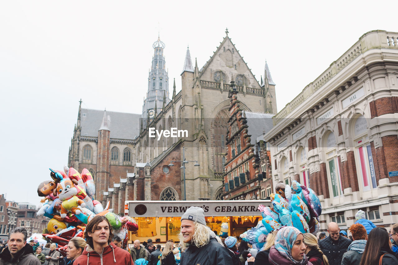 GROUP OF PEOPLE IN FRONT OF CATHEDRAL