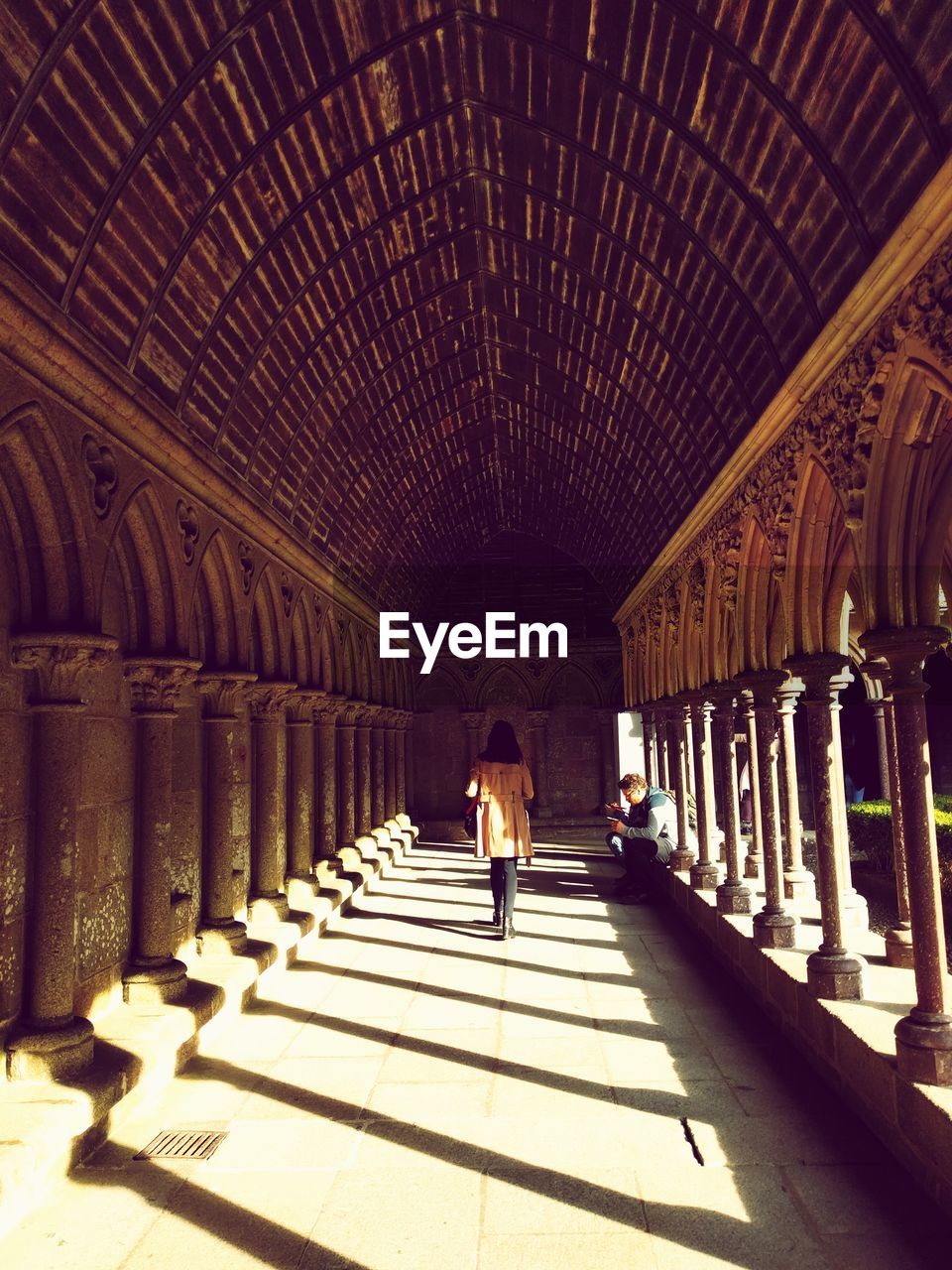 Rear view of woman walking in corridor