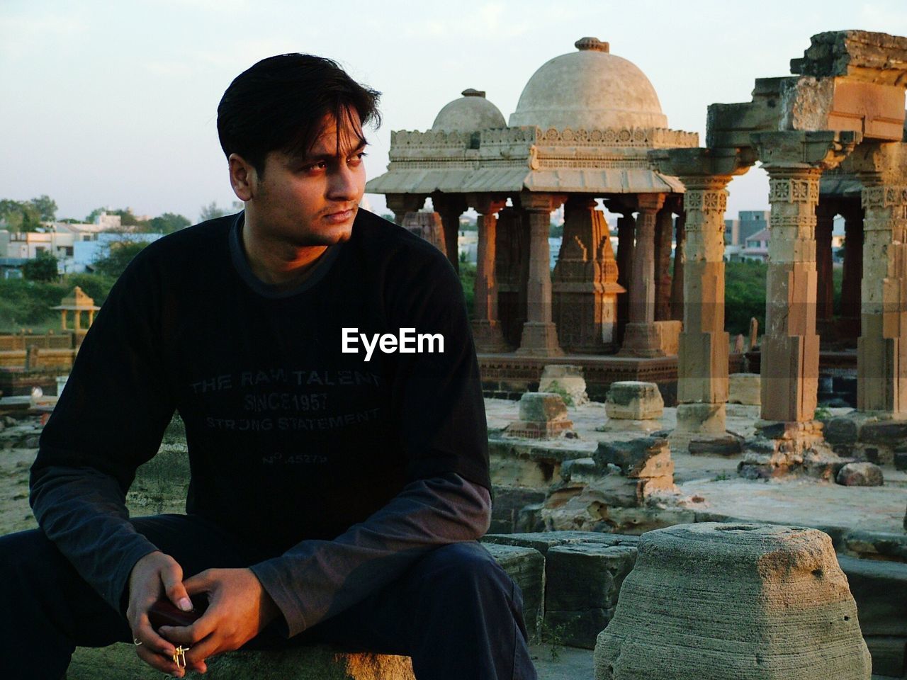 Young man visiting old ruins