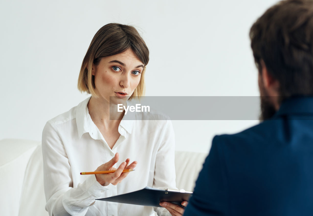 female doctor examining patient in clinic