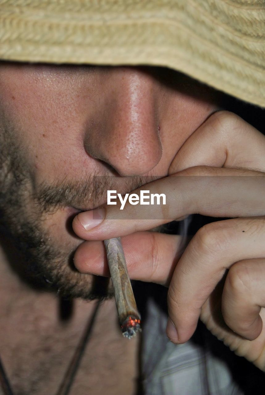 Close-up of man smoking marijuana