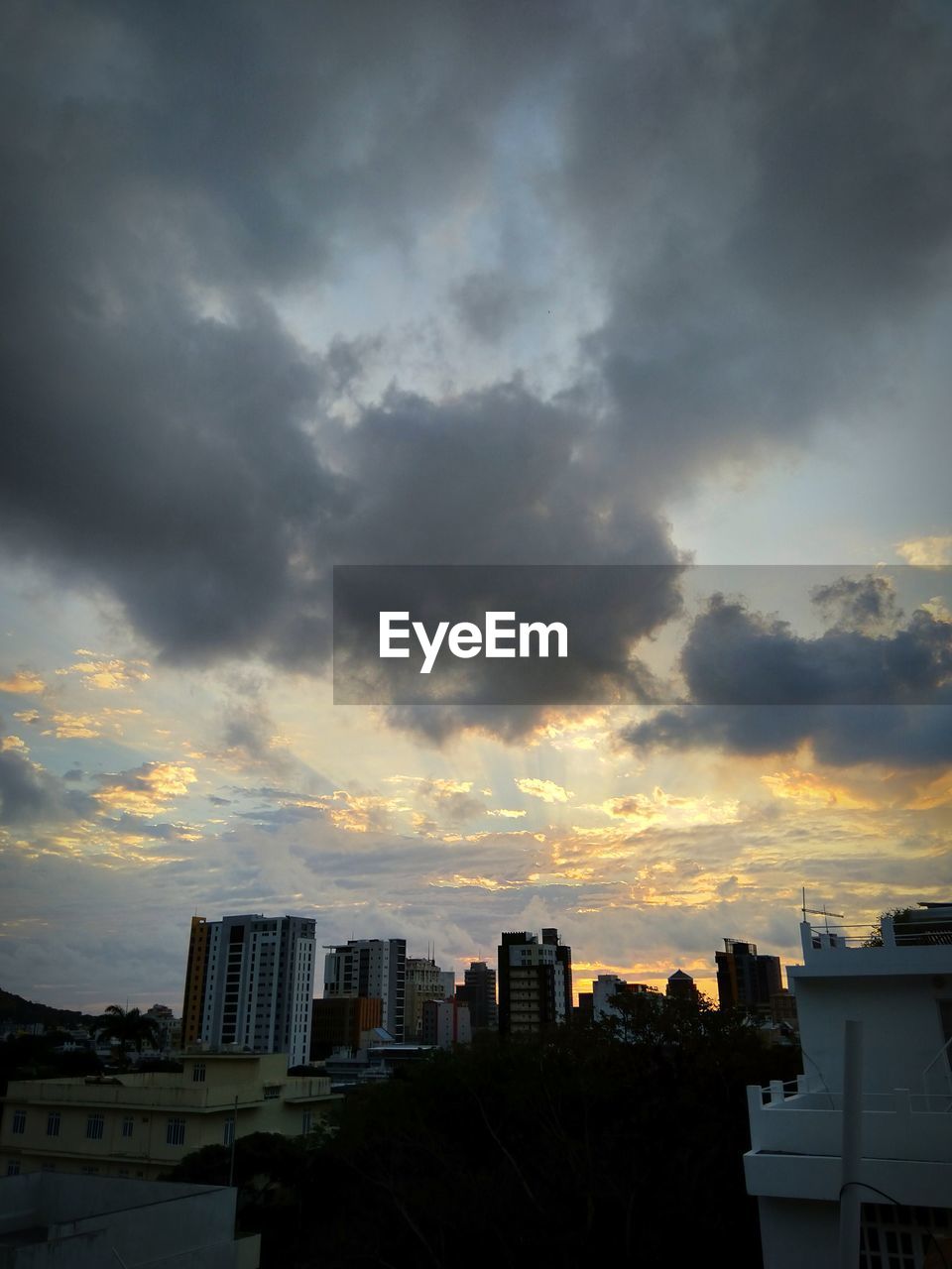 MODERN BUILDINGS AGAINST SKY DURING SUNSET