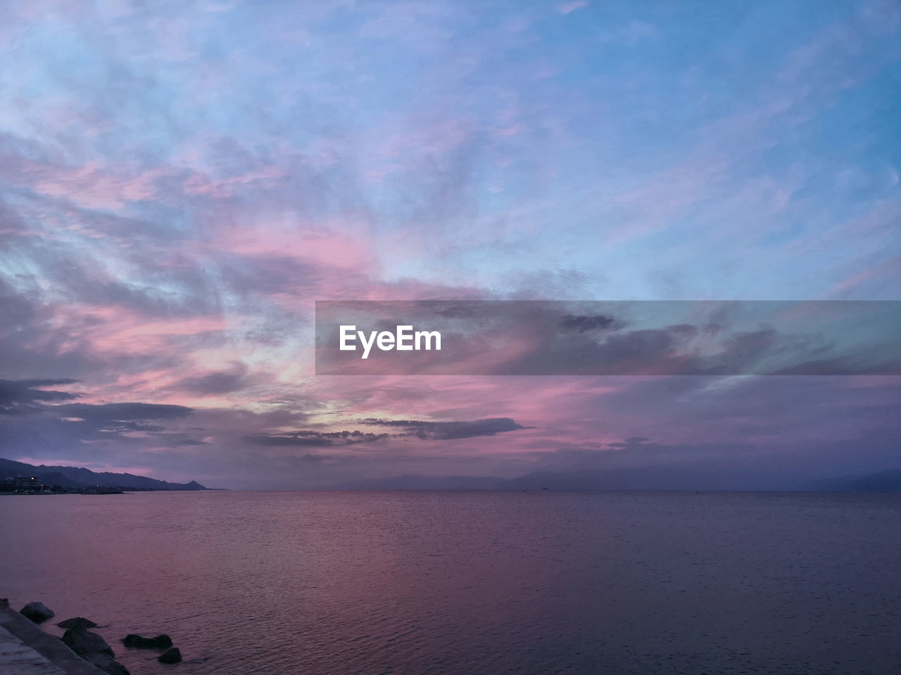 Scenic view of sea against sky at sunset