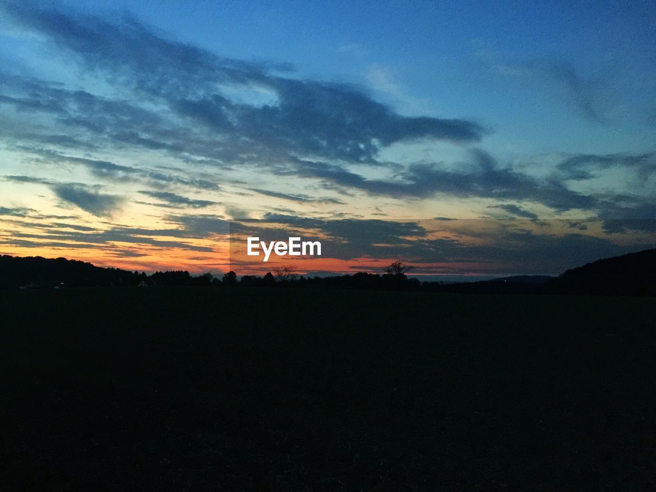 SILHOUETTE LANDSCAPE AGAINST SKY AT SUNSET